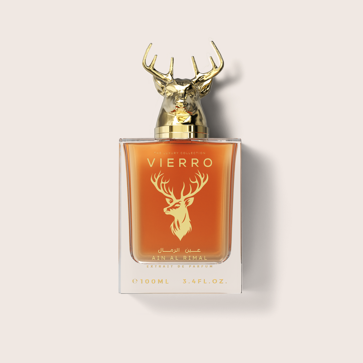 A 100ml bottle of ATN AL-THAL VIERRO Extrait de Parfum, featuring amber-colored liquid inside a clear glass bottle with a metallic gold deer head cap and gold lettering on the front, set against a light beige background.