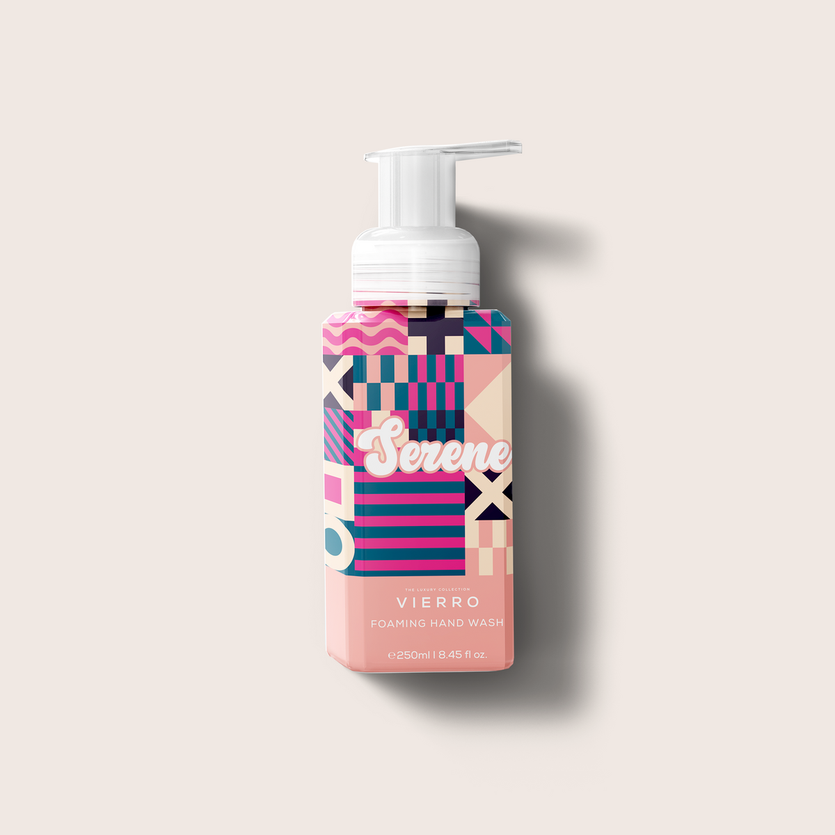 Colorful foaming hand wash bottle with geometric pattern on a light beige background