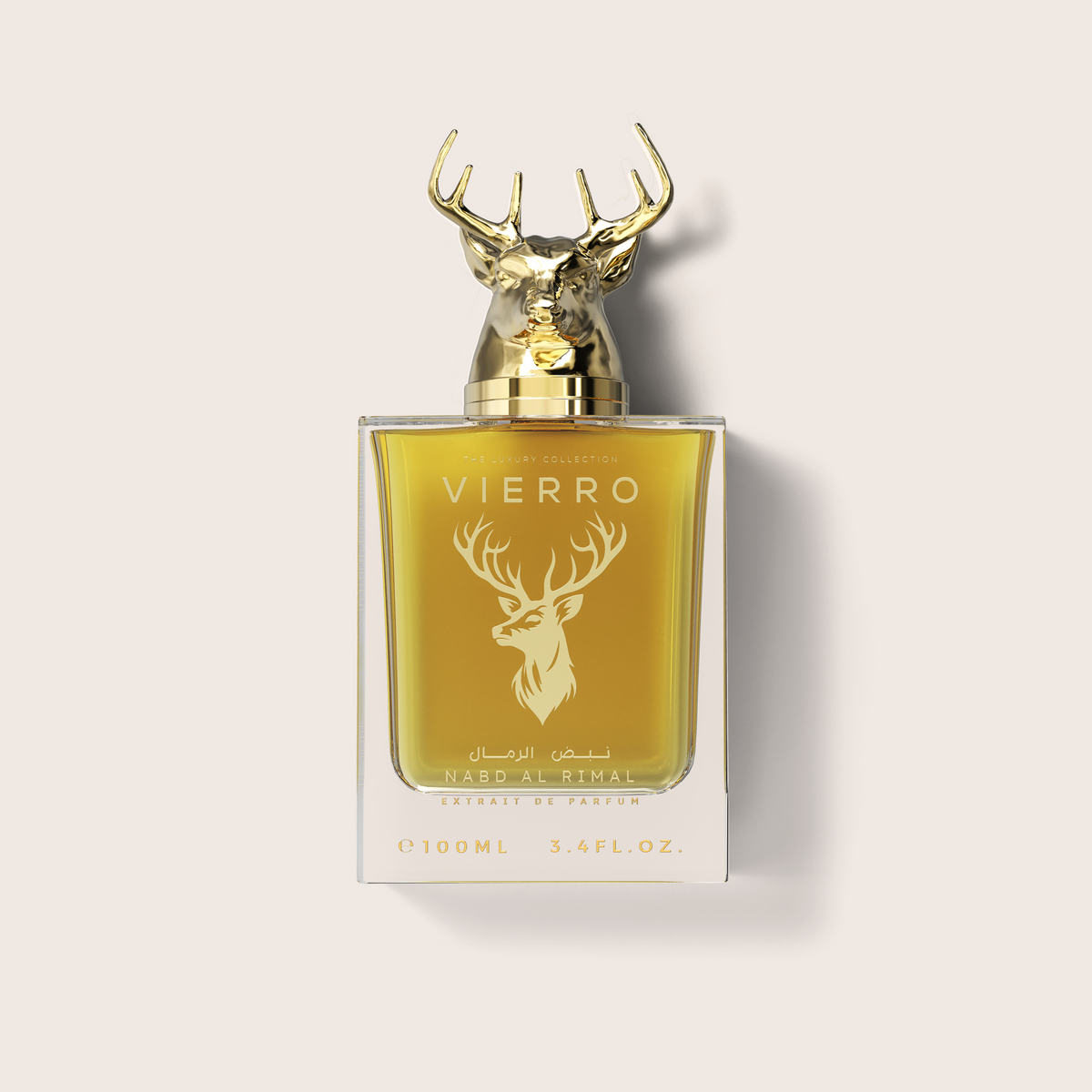 A 100ml bottle of Nasb Al-Rimal Vierro Extrait de Parfum, featuring a golden deer head cap and a gold deer logo on a yellow-gold liquid-filled bottle, set against a light beige background.